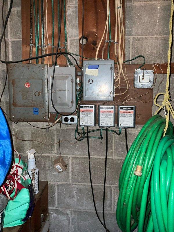 Conducted assessment for replacement of an aged propane boiler system in customer's basement. Existing installation shows significant wear with outdated electrical connections mounted on wooden backboard. Recommended replacement with new propane boiler system of comparable capacity, including proper electrical panel upgrades and PVC venting to meet current code requirements.