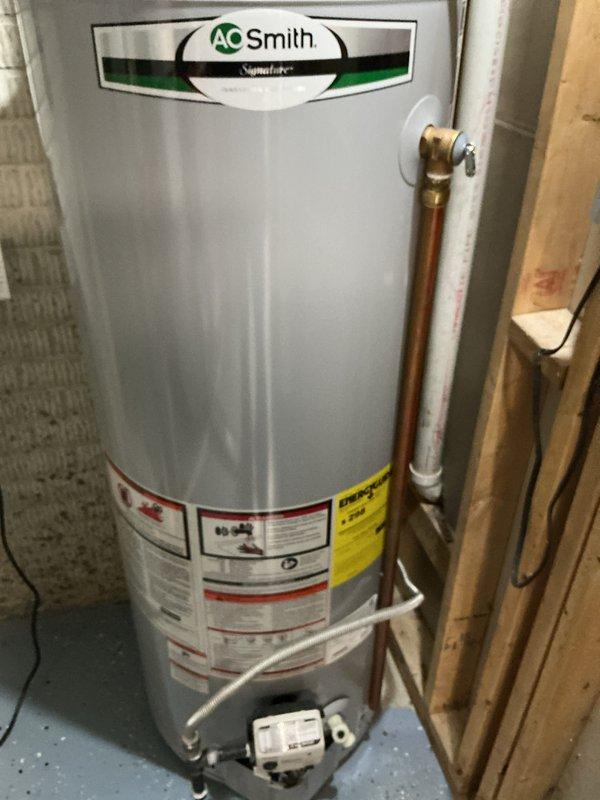 Performed maintenance on heating system under CCH Basic Plus agreement. Inspected A.O. Smith Signature water heater with copper and PVC connections. Examined existing air filter (20x25x4, not included in service) and documented condition with photos.