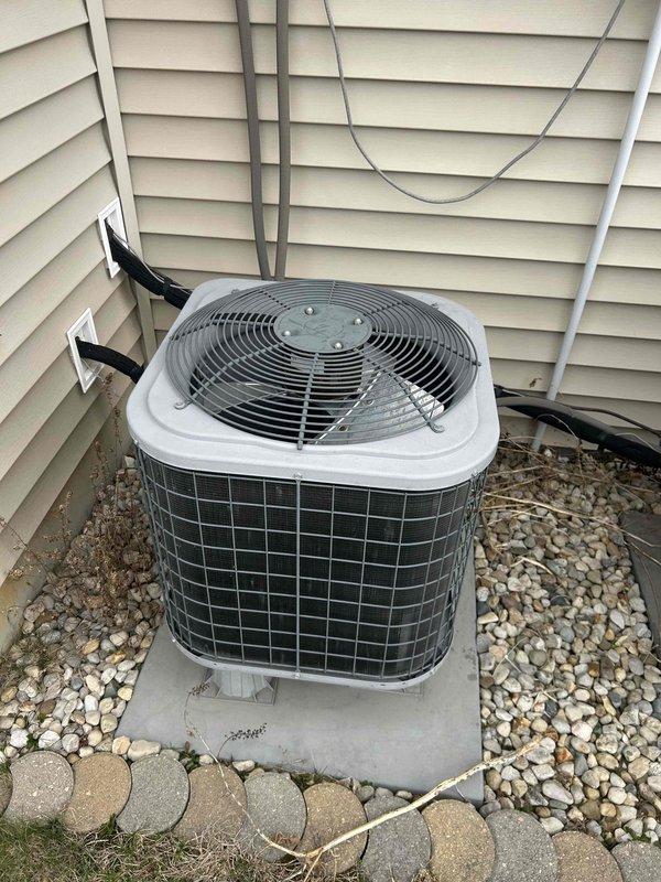 Conducted free second opinion service for non-cooling system that was blowing hot air. Diagnosed inoperative outdoor unit for upstairs with zero pressure reading and visible rust on top where unit had been running hot. Provided options for leak search or complete system replacement, noting that downstairs system was also underperforming. Documented condition with photos of both condenser units showing installation on concrete pad with proper clearance.