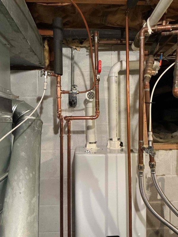 Successfully installed a new water softener system and tankless water heater in the basement utility area. Completed all necessary copper and PVC piping connections, including installation of appropriate valves and fittings for proper system operation. Final inspection confirmed all components are properly mounted, connected to power, and functioning according to specifications.