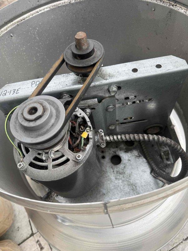 Diagnosed and repaired overheating exhaust fan motor located on roof that had fried wiring. Inspected belt drive system and mounting components, documenting condition with photos of motor assembly and mechanical components. Replaced damaged wiring to restore proper functionality to the ventilation system.