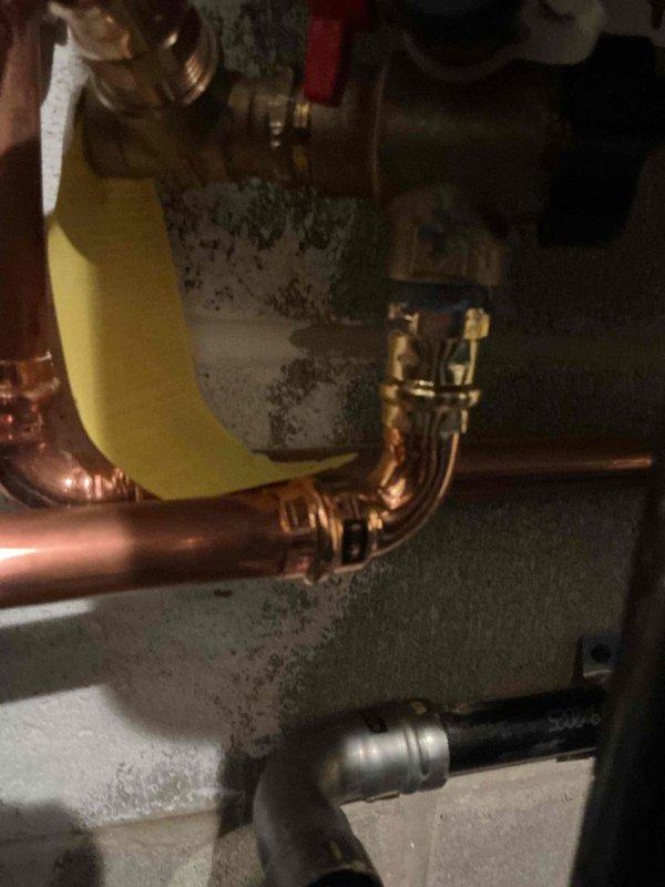 Responded to a callback for a recently installed tankless water heater exhibiting a leak at one of the copper pipe fittings. Inspected the plumbing connections, identified a loose compression fitting at the inlet valve assembly, and properly tightened the connection to eliminate the leak. Verified system operation with no further moisture issues.