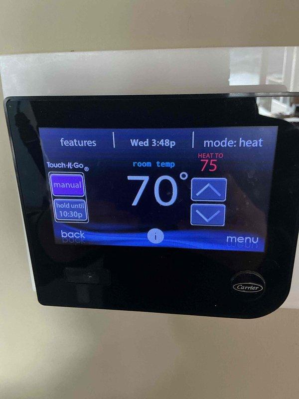 Performed monthly preventive maintenance on Carrier HVAC heating system. Inspected thermostat functionality (confirmed proper operation at 70°F current/75°F set point in heat mode) and examined control panel wiring connections for secure terminations and proper circuit board condition. All components functioning normally with no issues detected.
