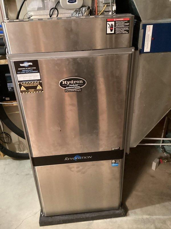 Responded to service call for a Hydron geothermal system stuck in loop with pump running but compressor not operating while all three zones were calling for heat. Upon inspection of the Revolution unit, found system would temporarily function after thermostat reset. Diagnosed faulty control board with improper signal processing at terminal connections, replaced board and verified proper operation across all zones.