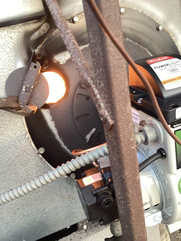 Responded to service call for oil furnace in greenhouse exhibiting excessive soot and smoke during operation. Inspection revealed significant carbon buildup in combustion chamber and deteriorated chimney pipe with visible rust and weathering. Performed thorough cleaning of heat exchanger, adjusted air/fuel mixture for proper combustion, and recommended replacement of compromised exhaust components to prevent further soot accumulation and ensure safe operation.