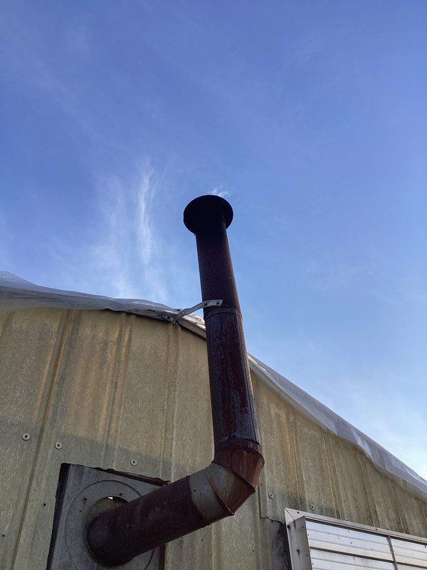 Responded to service call for oil furnace in greenhouse exhibiting excessive soot and smoke during operation. Inspection revealed significant carbon buildup in combustion chamber and deteriorated chimney pipe with visible rust and weathering. Performed thorough cleaning of heat exchanger, adjusted air/fuel mixture for proper combustion, and recommended replacement of compromised exhaust components to prevent further soot accumulation and ensure safe operation.