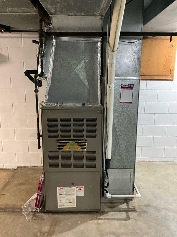 Inspected 1999 furnace exhibiting intermittent fault codes related to condensation issues in the collector box and inducer assembly. System evaluation revealed aging components in basement installation with visible water staining near unit base, confirming moisture problems. Recommended complete system replacement to address recurring faults and potential safety concerns, with options presented for compatible integration with existing 2023 Lennox AC unit.