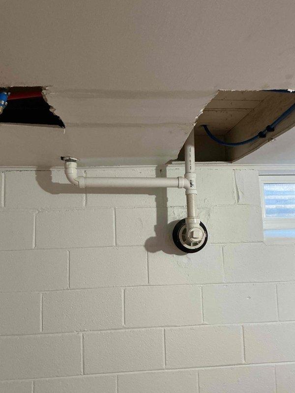 Performed prepaid plumbing inspection of customer's water treatment system, which included a nuvo H2O filter unit connected to blue PVC pipes with brass fittings in a bypass configuration. Also inspected ceiling access areas where plumbing penetrations were visible and examined PVC drain pipe with cleanout cap; all components appeared to be in proper working condition with no visible leaks or damage.