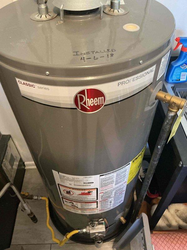 Performed annual maintenance service on Rheem Classic series Professional water heater (installed 4-6-18) and inspected HVAC system. Removed access panel to examine internal components including circuit board, wiring connections, and motor assembly. All systems functioning properly with no issues identified.