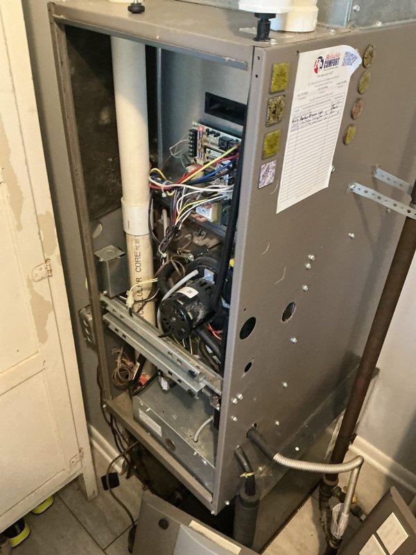Performed annual maintenance service on Rheem Classic series Professional water heater (installed 4-6-18) and inspected HVAC system. Removed access panel to examine internal components including circuit board, wiring connections, and motor assembly. All systems functioning properly with no issues identified.