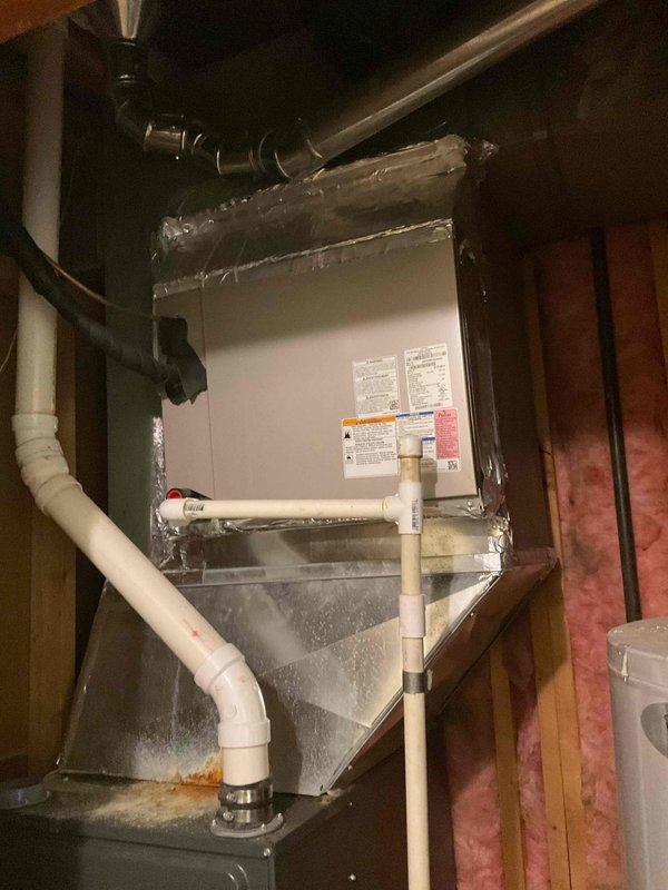 Conducted site inspection for potential AC unit relocation as requested by customer. Evaluated current HVAC system, including furnace installation, ductwork configuration, and drainage components. Documented existing mechanical room setup with exposed joists and fiberglass insulation to assess feasibility of moving outdoor condensing unit to opposite side of residence.