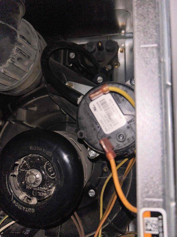 Diagnosed furnace issue where system powered on but failed to produce heat. Inspected blower motor assembly and pressure switch components. Visual inspection revealed potential issues with the pressure switch and associated copper tubing connections that were preventing proper system operation.