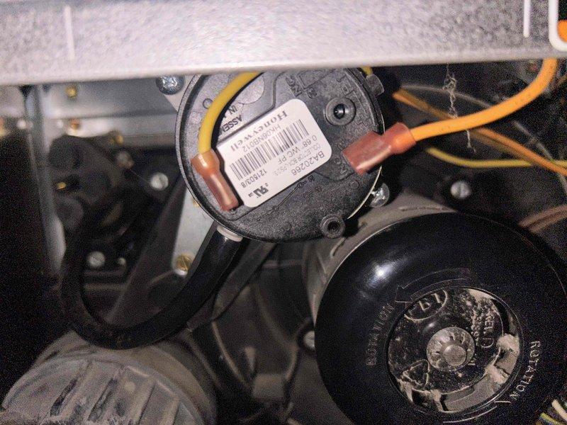 Diagnosed furnace issue where system powered on but failed to produce heat. Inspected blower motor assembly and pressure switch components. Visual inspection revealed potential issues with the pressure switch and associated copper tubing connections that were preventing proper system operation.