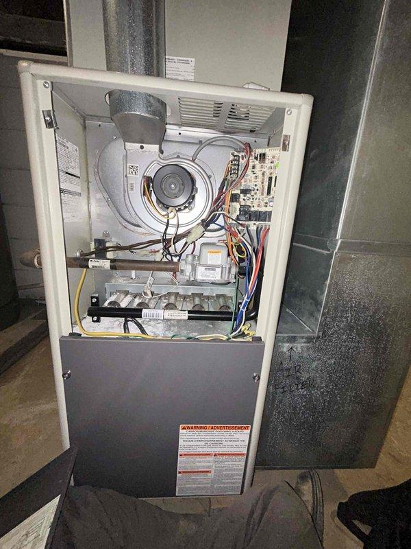 Diagnosed furnace that was cycling frequently and delivering cool air despite thermostat being set to heat at 79°F. Performed inspection of internal components including blower motor assembly, circuit board, and electrical connections. Customer's Airtemp furnace was examined with front panel removed to troubleshoot the heating system malfunction.
