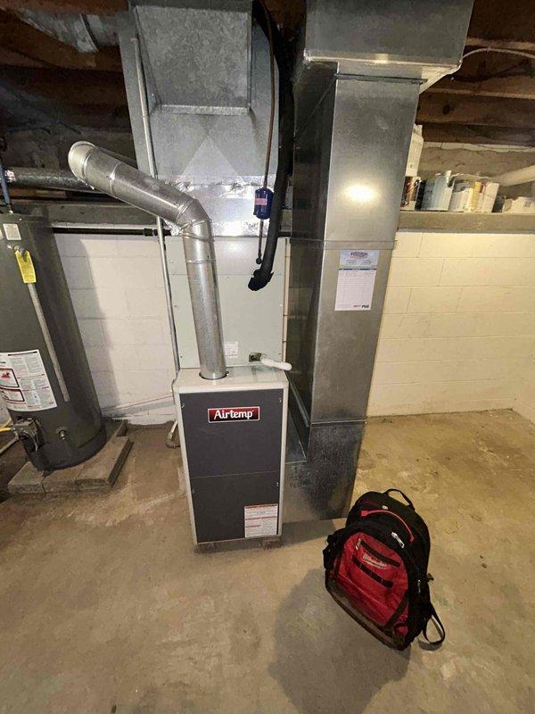 Diagnosed furnace that was cycling frequently and delivering cool air despite thermostat being set to heat at 79°F. Performed inspection of internal components including blower motor assembly, circuit board, and electrical connections. Customer's Airtemp furnace was examined with front panel removed to troubleshoot the heating system malfunction.