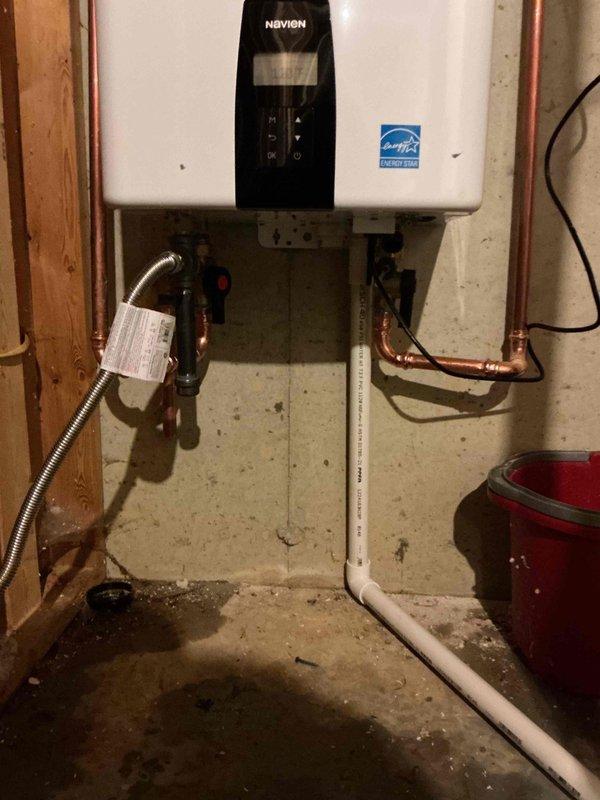 Successfully installed a new Navien tankless water heater system to replace the previously malfunctioning unit. Completed all necessary copper pipe connections, gas line hookup with appropriate safety measures, and PVC condensate drainage. System was properly mounted on concrete foundation wall, tested for proper operation, and confirmed to be functioning according to manufacturer specifications.