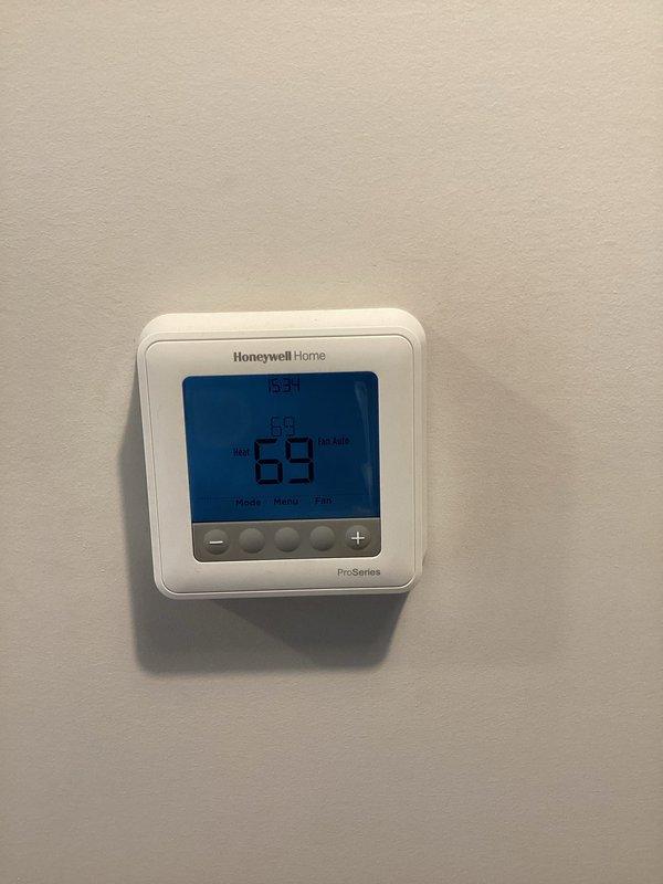 Performed monthly maintenance on heating system. Inspected interior mechanical compartment which showed dust accumulation on metal surfaces and ductwork. Verified Honeywell ProSeries thermostat operation with system maintaining 69°F temperature and 63% humidity in heat mode.