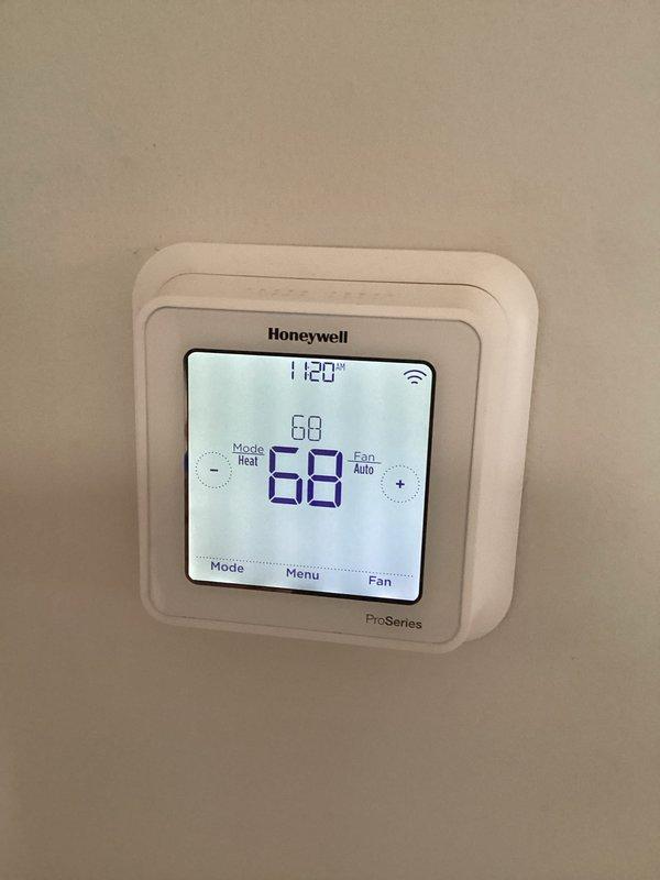 Performed scheduled winter heating tune-up on customer's HVAC system. Inspected Honeywell ProSeries thermostat, confirming proper operation in Heat mode with Auto fan setting. Verified wireless connectivity and temperature calibration between set point and ambient temperature readings.