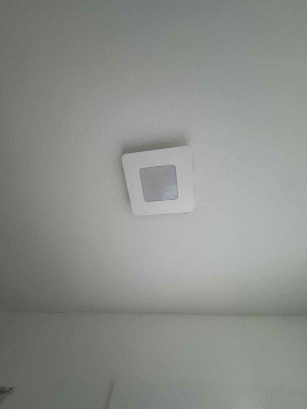 Completed installation of smoke detectors and finished various electrical components in new construction including dining room outlets, kitchen outlets behind stove/backsplash, and dryer electrical connections. Installed lighting fixtures including front porch recessed lights, back porch light, and bathroom light/exhaust fan units in master and guest bathrooms.