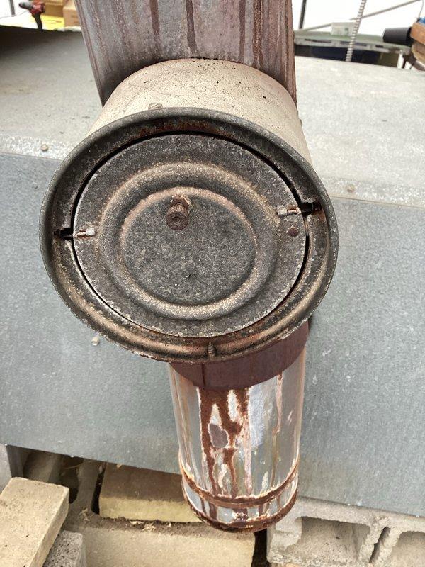 Responded to callback for boiler exhibiting black smoke emissions after warm-up period. Inspected deteriorated cast iron exhaust components and burner assembly with green control module. Adjusted fuel-air mixture settings to correct incomplete combustion issue, eliminating smoke production during operation.