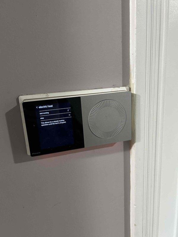 Performed monthly maintenance on heating system with Daikin equipment. Inspected thermostat settings for electric heat operation and verified proper functionality. Exterior condenser unit was examined and found to be in normal operating condition with adequate clearance and proper drainage base.