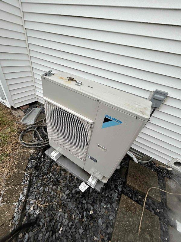 Performed monthly maintenance on heating system with Daikin equipment. Inspected thermostat settings for electric heat operation and verified proper functionality. Exterior condenser unit was examined and found to be in normal operating condition with adequate clearance and proper drainage base.