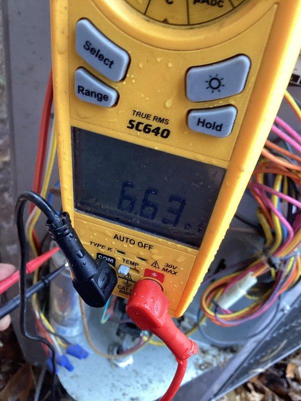Conducted diagnostic testing on outdoor heat pump system that was emitting intermittent humming alert sounds. Performed electrical testing using SC640 digital multimeter, specifically checking capacitor connections and readings. Identified faulty run capacitor showing abnormal readings (663) as root cause of system noise. Replaced defective capacitor to resolve the intermittent alarm condition.