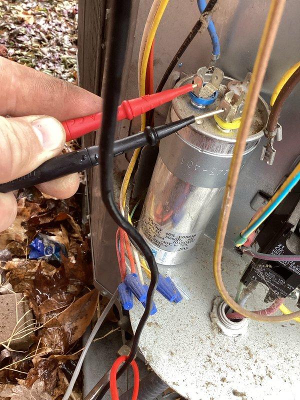 Conducted diagnostic testing on outdoor heat pump system that was emitting intermittent humming alert sounds. Performed electrical testing using SC640 digital multimeter, specifically checking capacitor connections and readings. Identified faulty run capacitor showing abnormal readings (663) as root cause of system noise. Replaced defective capacitor to resolve the intermittent alarm condition.