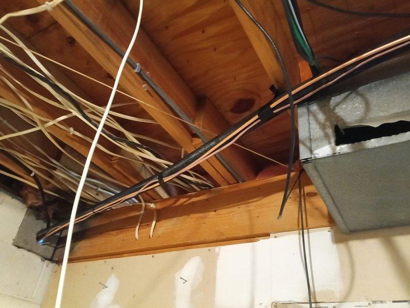 Successfully relocated customer's AC condensing unit from the rear of the residence to the left side of the house. Installation included mounting the unit on a concrete pad, connecting electrical service via properly installed disconnect box, and routing necessary refrigerant lines through the basement ceiling joists. Unit was tested and confirmed to be operating within manufacturer specifications after relocation.