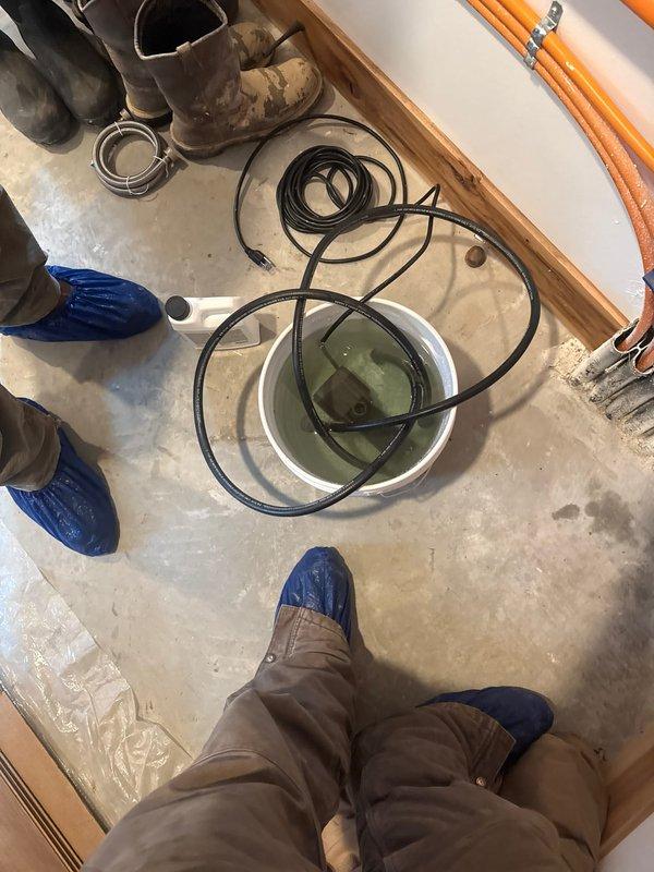 Performed a complete flush of the boiler system to remove sediment and contaminants, evidenced by the greenish discharge collected in the containment bucket. Inspected the wall-mounted unit with digital controls and Energy Star certification, verifying proper operation and temperature readings after service completion.