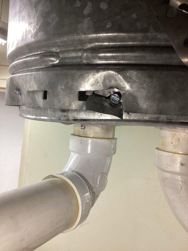 Responded to emergency water alarm activation at commercial property. Discovered water accumulation on floor beneath HVAC condensate drain system. Inspected galvanized metal housing and PVC drainage pipes, identified blockage in primary condensate line causing overflow. Cleared obstruction, verified proper drainage function, and confirmed system operation before departure.