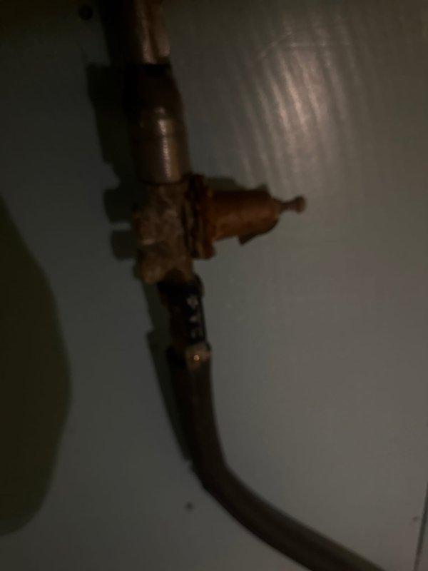 Responded to service call for water heater leaking from temperature and pressure relief valve overflow, which had been dripping consistently for over a week. Inspected system and found pressure regulator functioning improperly, causing excessive pressure in the water heater. Adjusted pressure regulator to proper PSI range and verified normal operation of the T&P valve with no further discharge.