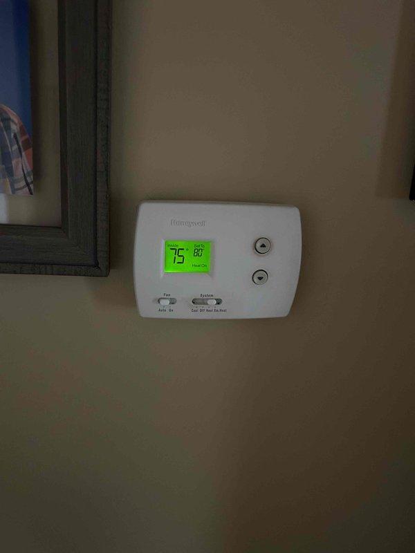 Replaced faulty control board in HVAC system after diagnosing thermostat communication issues. Removed existing circuit board from metal housing enclosure, installed new Honeywell-compatible board, and reconnected all wiring harnesses (red, blue, black, yellow, brown, and white). System now functioning correctly with proper temperature control.