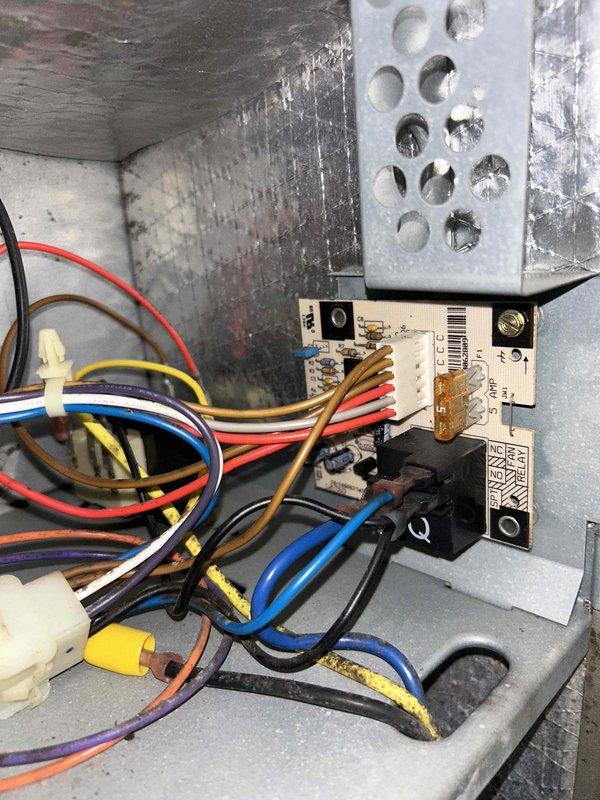 Replaced faulty control board in HVAC system after diagnosing thermostat communication issues. Removed existing circuit board from metal housing enclosure, installed new Honeywell-compatible board, and reconnected all wiring harnesses (red, blue, black, yellow, brown, and white). System now functioning correctly with proper temperature control.