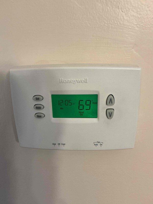 Performed Basic Monthly CCH maintenance service on heating system. Removed and cleaned washable filters. Verified thermostat operation - unit functioning properly in Heat mode at 69°F with "Heat On" status displayed on Honeywell digital thermostat.