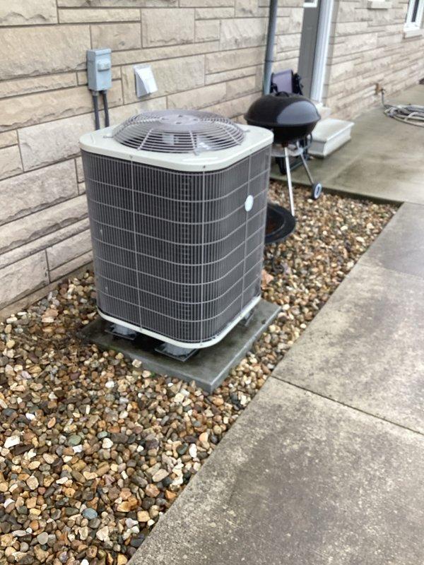 Performed monthly basic heating maintenance service on the system. Inspected outdoor condensing unit and verified proper installation on concrete pad with adequate clearance. Checked Honeywell ProSeries thermostat operation, confirming proper heat mode function with temperature reading at 74°F and fan in auto setting.