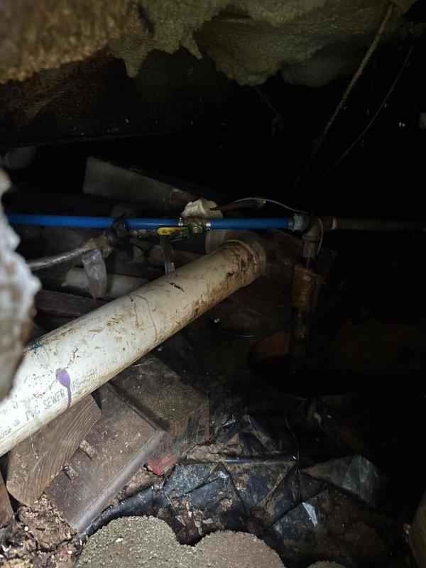 Responded to emergency call for a burst pipe near the shut-off valve in a mobile home. Accessed confined crawlspace to locate the damaged section where PVC and PEX lines connect. Replaced the failed valve assembly and verified system integrity with pressure test after repair.
