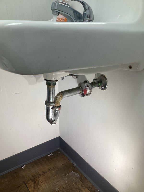 Diagnosed and repaired leaking bathroom sink faucet exhibiting slow drip. Inspection revealed corroded internal components and mineral buildup on chrome fixtures, particularly at connection points. Replaced worn seals and adjusted fittings to restore proper function and eliminate leak.