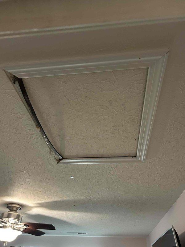 Performed second opinion diagnosis on Bryant HVAC system that was not producing cool air despite unit activation. Inspection revealed damaged ceiling access panel and examined attic-mounted air handler. Determined system requires repair to restore proper cooling function for homeowner who is preparing property for sale.