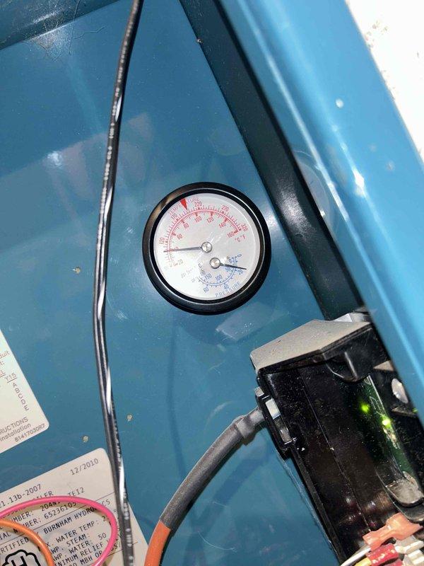 Responded to customer complaint of unusual boiler noise suspected to be air in the system. Performed diagnostic checks including thermostat inspection (confirmed set at 71°F with actual temperature reading 84°F) and pressure gauge evaluation. Purged air from system which resolved the noise issue and restored normal operation.