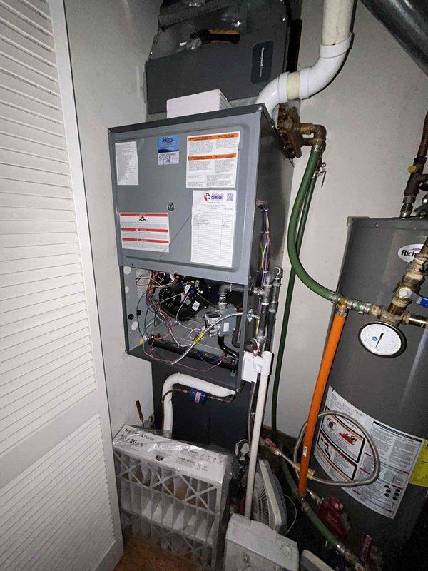 Performed routine maintenance on residential heating system, including inspection of furnace components, control board, and wiring. Checked thermostat functionality, confirming proper operation of both the Honeywell control unit and digital display interface. System is operational with no issues detected.