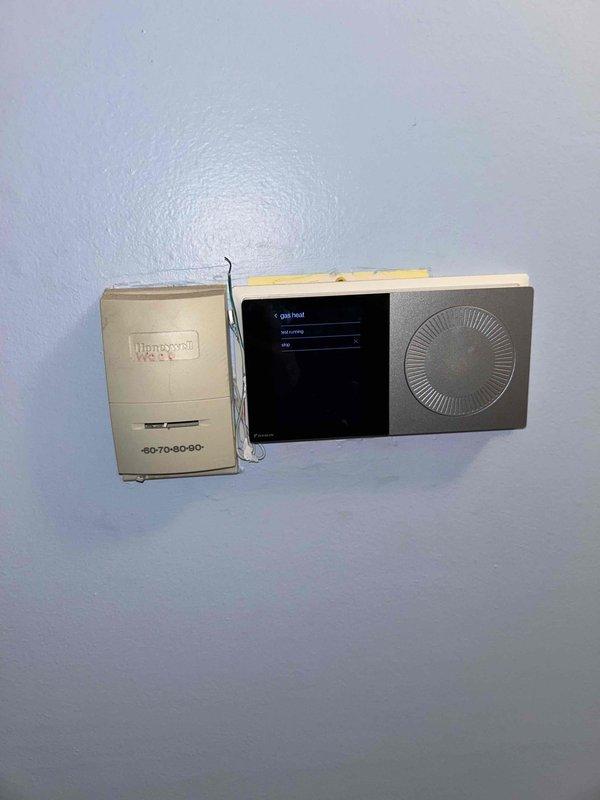 Performed routine maintenance on residential heating system, including inspection of furnace components, control board, and wiring. Checked thermostat functionality, confirming proper operation of both the Honeywell control unit and digital display interface. System is operational with no issues detected.