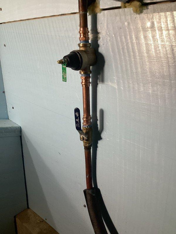 Successfully installed a new 3/4" Watts pressure reducing valve (25-75 PSI range) and thermal expansion tank on the customer's copper water supply line. PRV was properly calibrated to 50 PSI to protect plumbing fixtures and prevent excessive pressure in the system. Verified proper operation of both components and confirmed no leaks at connection points.
