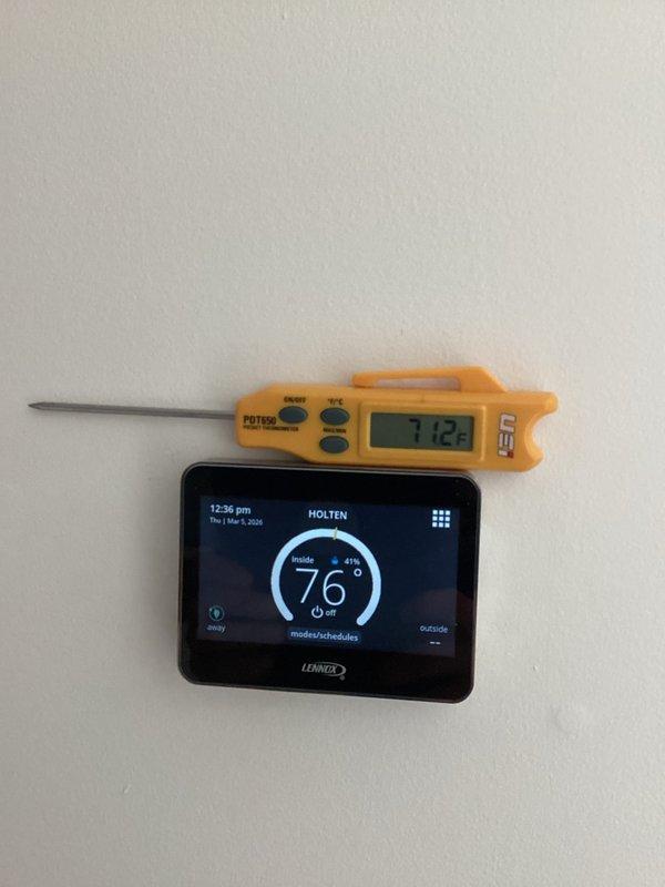 Performed diagnostic assessment on Lennox heat pump system reporting thermostat ambient lockout issues. Verified temperature discrepancy between thermostat reading (76°F) and actual ambient temperature (71.2°F per calibrated PDT22 probe). Corrected system configuration by enabling outdoor sensor setting in thermostat programming menu, resolving continuous operation problem and restoring normal cycling function.