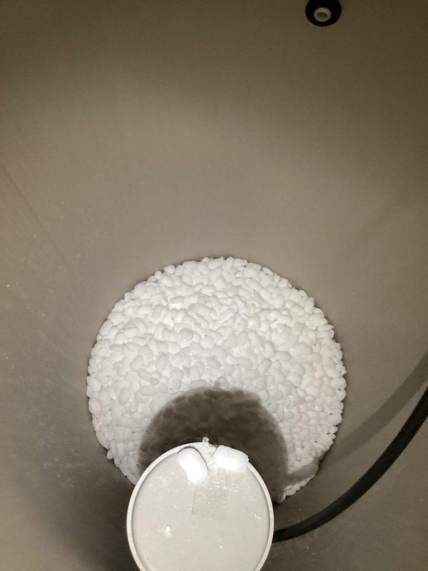 Responded to service call for water leak from bottom of North Star water softener system. Inspected the unit and identified damaged internal distribution valve causing water to leak from base of tank. Replaced faulty valve component and verified proper operation of system with no further leakage observed.