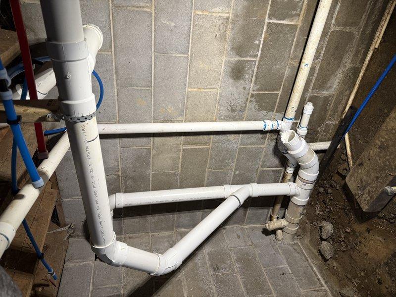 Responded to a service call for recurring sewer backup. Conducted thorough inspection of the PVC drainage system installed against concrete block wall, documenting the network of pipes, joints, and connections. Identified and cleared blockage in the main drainage line, ensuring proper flow through the entire system.