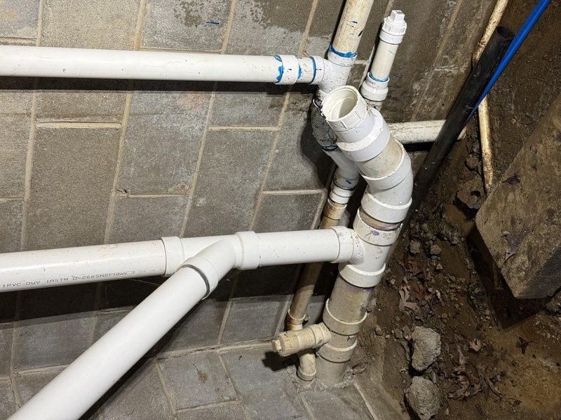 Responded to a service call for recurring sewer backup. Conducted thorough inspection of the PVC drainage system installed against concrete block wall, documenting the network of pipes, joints, and connections. Identified and cleared blockage in the main drainage line, ensuring proper flow through the entire system.