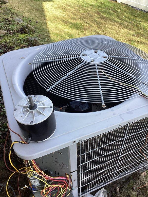 Replaced defective condenser fan motor on outdoor AC unit to restore system functionality. Verified proper electrical connections and confirmed system operation via thermostat, with cooling now functioning at set temperature (67°F) and fan operating correctly.