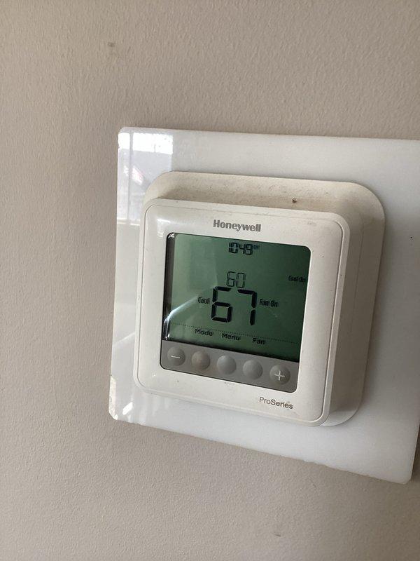 Replaced defective condenser fan motor on outdoor AC unit to restore system functionality. Verified proper electrical connections and confirmed system operation via thermostat, with cooling now functioning at set temperature (67°F) and fan operating correctly.