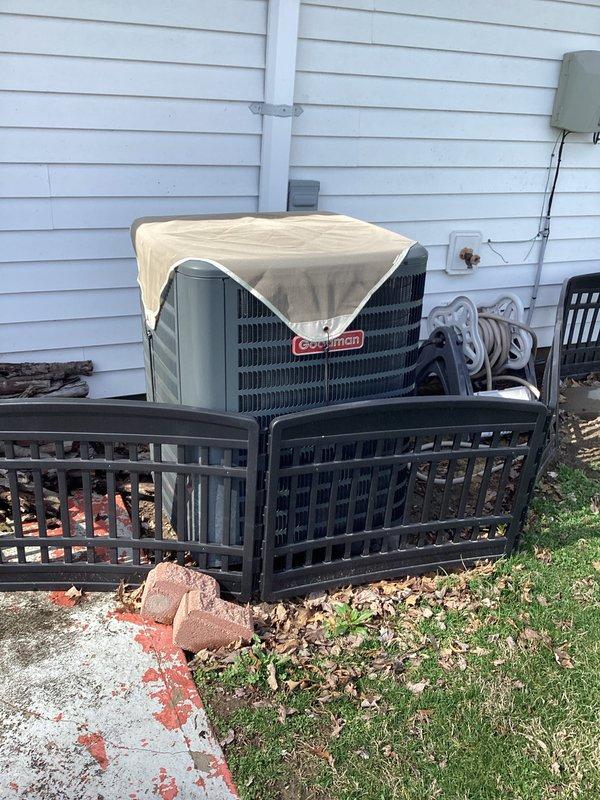 Performed monthly basic heating maintenance service on CCHP system. Inspected Sensi thermostat (displaying 69°F/69% humidity), which was functioning correctly with system off. Visual inspection of Goodman outdoor unit showed proper installation with protective cover in place, though some yard debris was noted around the unit perimeter.